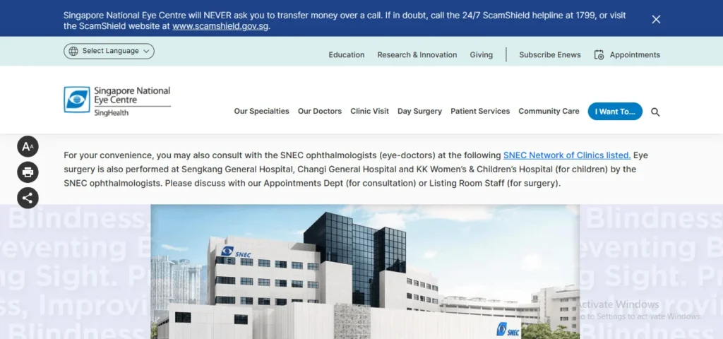 Screenshot of the Singapore National Eye Centre (SNEC) website homepage, featuring a prominent blue scam warning banner at the top, main navigation links, text about consulting with SNEC ophthalmologists, and a large photograph of the modern, multi-story SNEC building at the bottom.