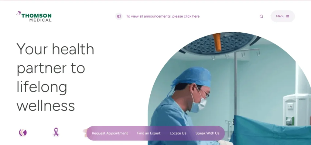 Homepage banner for Thomson Medical featuring the headline "Your health partner to lifelong wellness" alongside an image of a medical professional in an operating room.