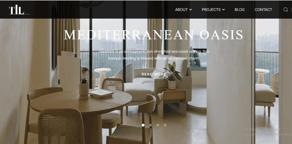 Modern Mediterranean style living and dining room designed by TIL in Singapore, featuring a light wood dining table with woven chairs, a cream sofa, and a balcony overlooking a city skyline view.