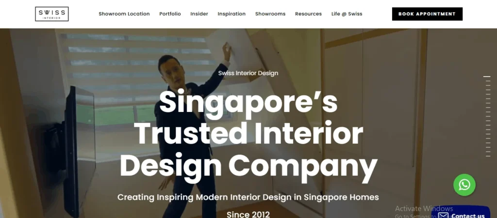Modern home interior designed by Swiss Interior in Singapore, featuring space saving custom cabinetry and a professional demonstrating a pull down wall bed setup.