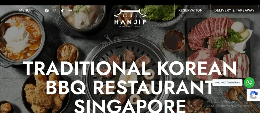 Website homepage of Hanjip Korean Grill House featuring a traditional Korean BBQ table layout with meats and a tabletop grill.