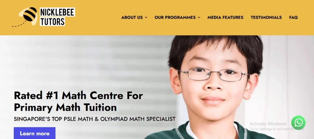 "Website header and banner for Nicklebee Tutors, featuring a prominent close-up of a young Asian student wearing glasses. Text on the banner highlights them as the 'Rated #1 Math Centre For Primary Math Tuition' and 'Singapore’s Top PSLE Math & Olympiad Math Specialist' next to a blue 'Learn more' button. The top navigation header is a warm yellow color with a bee logo."