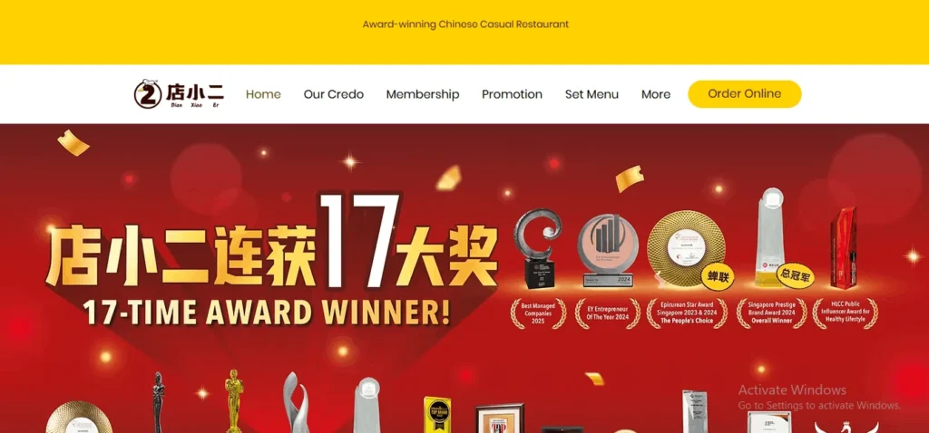 "Website homepage for Dian Xiao Er, an award-winning Chinese casual restaurant. The top section features a white header with the restaurant's logo and navigation links, under a yellow bar. Below, a prominent red promotional banner celebrates being a '17-TIME AWARD WINNER!' with bold gold text in both English and Chinese. Various trophies and accolades are displayed on the right, including Best Managed Companies 2025 and EY Entrepreneur Of The Year 2024."