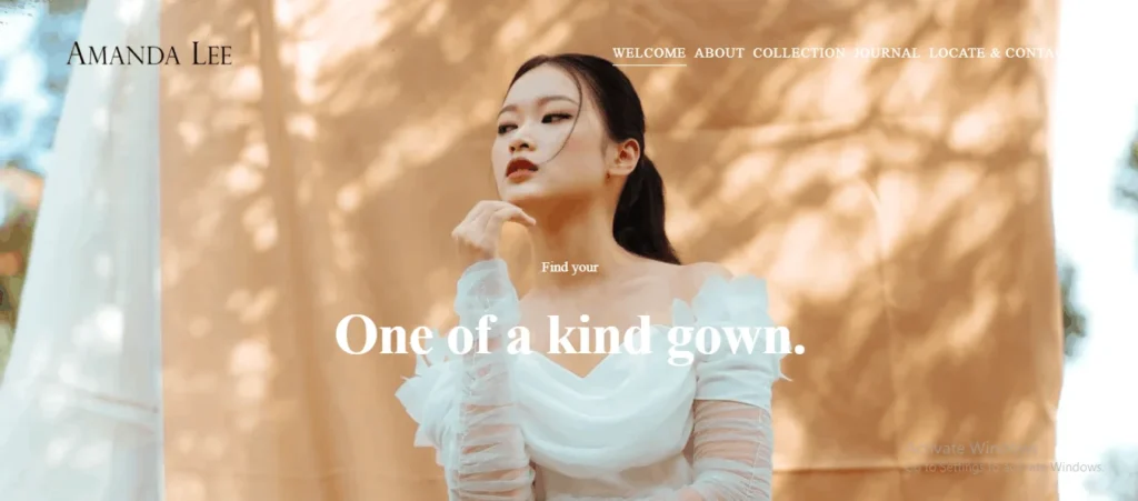 Homepage hero banner for Amanda Lee Weddings, featuring a model in a unique off-the-shoulder white bridal gown against a warm beige fabric backdrop with dappled sunlight. Text overlay reads "Find your One of a kind gown."