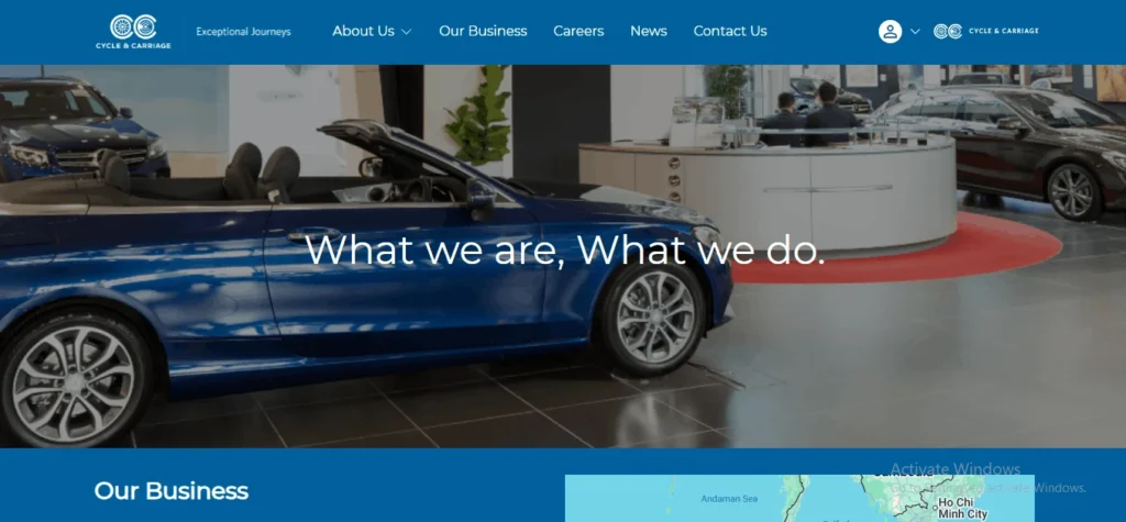 Cycle & Carriage Singapore corporate website banner displaying a blue convertible sports car inside an automotive dealership with a curved reception desk.