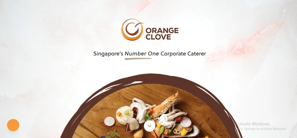 Promotional banner for Orange Clove catering, featuring the text "Singapore's Number One Corporate Caterer" above a circular platter of fresh seafood.