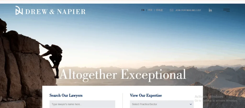 Screenshot of the homepage for law firm "DREW & NAPIER". The top header displays the firm's logo on the left, language options ("EN", "中文", "日本語"), "JOIN OUR MAILING LIST", a LinkedIn icon, and a hamburger navigation menu. The banner image shows a rock climber ascending a steep cliff edge overlooking a mountain range at sunrise, with large white overlay text reading "Altogether Exceptional". At the bottom, a white search widget offers input fields to "Search Our Lawyers" and "View Our Expertise".