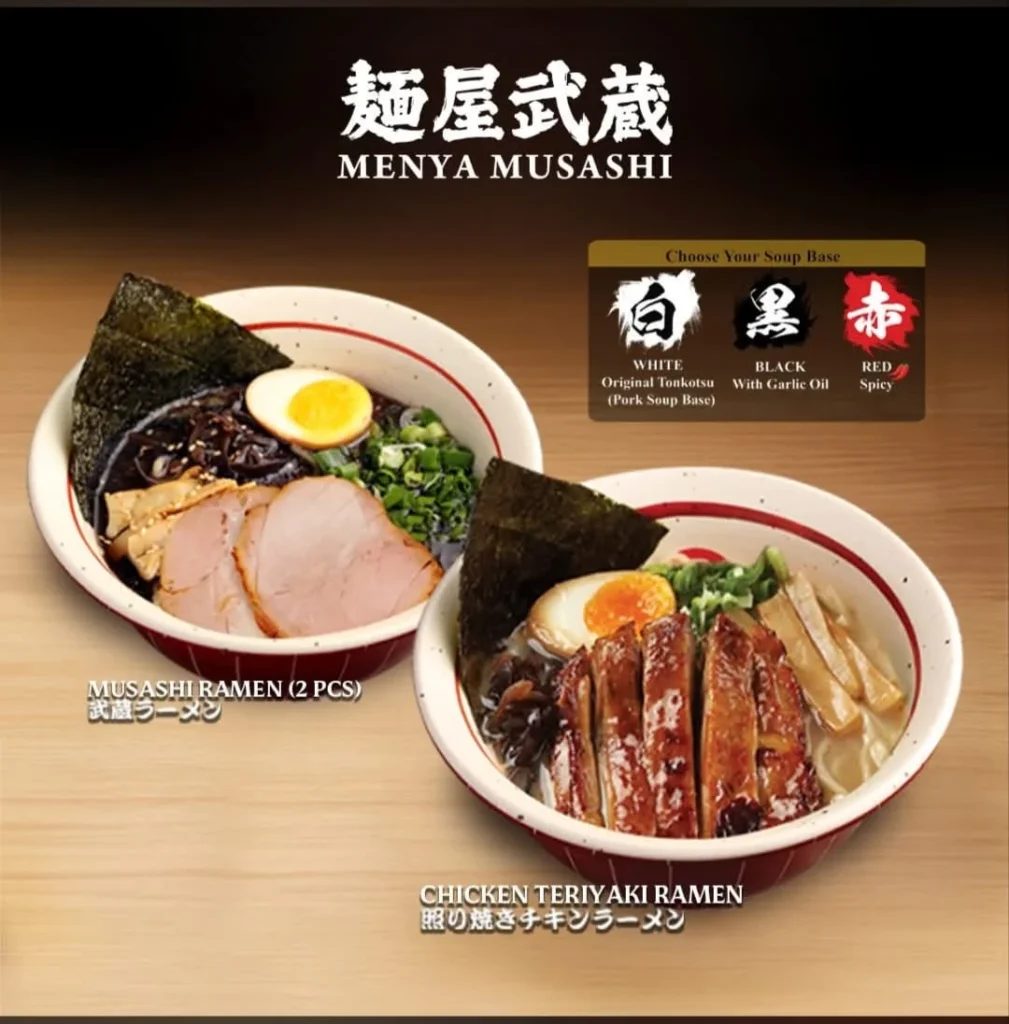 A promotional menu image for Menya Musashi featuring two bowls of ramen. The left bowl is "Musashi Ramen (2 Pcs)" with sliced chashu pork, and the right bowl is "Chicken Teriyaki Ramen" with sliced teriyaki chicken. Both include a soft-boiled egg, nori, and green onions. A "Choose Your Soup Base" section at the top right options White (Original Tonkotsu), Black (With Garlic Oil), and Red (Spicy).