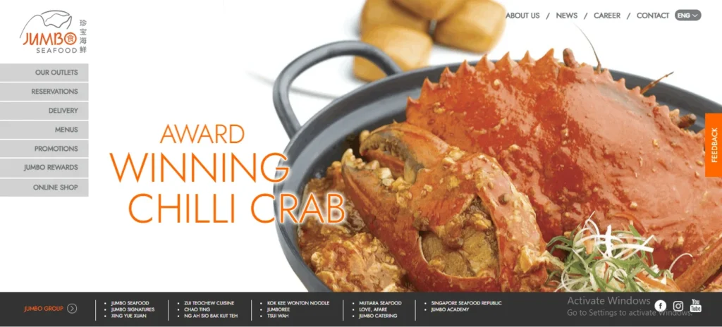 Website homepage for Jumbo Seafood featuring a large, close-up image of a cooked award-winning chilli crab in a black wok, served with a rich orange-red sauce.