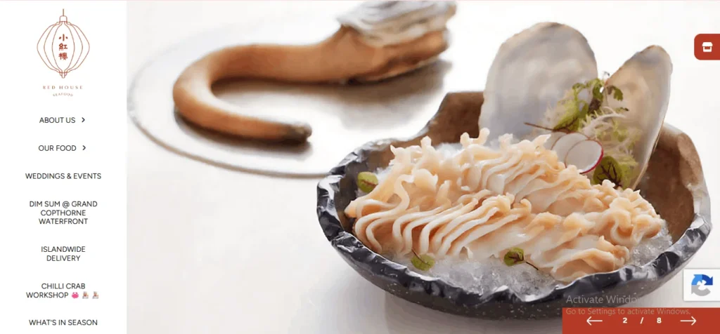 A website homepage screenshot for Red House Seafood, featuring a close-up photo of thinly sliced geoduck sashimi arranged on a bed of crushed ice inside a dark, textured bowl shaped like a seashell. A whole geoduck clam shell stands upright in the background of the bowl as decoration. On the left side, a white navigation sidebar displays the restaurant's lantern logo and menu links, including "About Us," "Our Food," and "Chilli Crab Workshop."