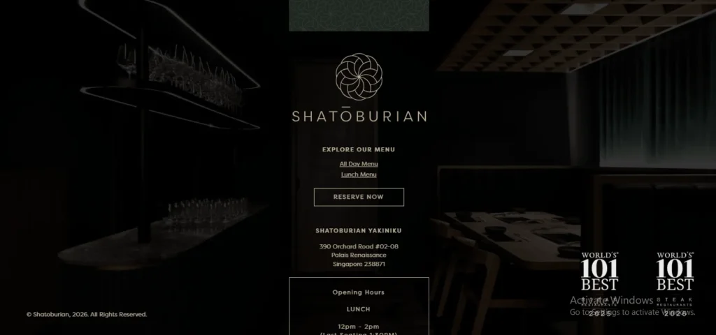 A dark, elegant website interface for Shatoburian Yakiniku steakhouse in Singapore, featuring a central gold logo, menu links, address details, and a glimpse of a dimly lit restaurant interior.