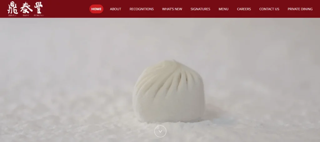 Din Tai Fung website homepage showing a single steamed Chinese soup dumpling (xiao long bao) on a white background, featuring the restaurant's red navigation menu header.