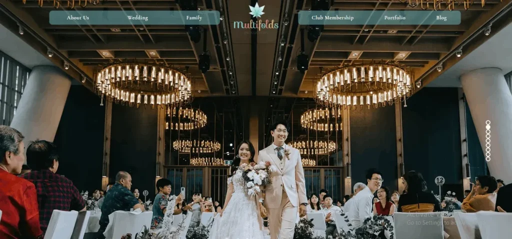 Website banner screenshot for Multifolds Productions showing a bride and groom walking down the aisle during a luxury indoor wedding reception in Singapore.