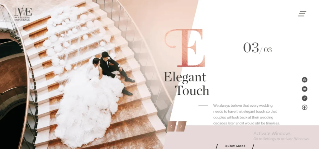 Website banner for The Wedding Entourage featuring a bride in a large ruffled gown and a groom in a tuxedo sitting together on a grand staircase decorated with white floral arrangements.